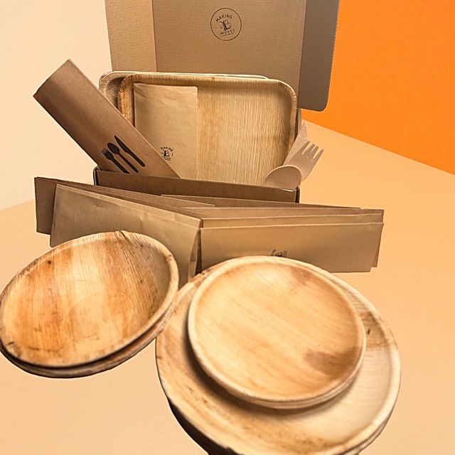 The 5 day kit: palm-leaf plates and bowls, wrapped cutlery, and napkins in the box